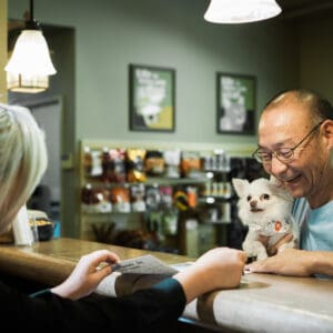 Cascade Kennels customer checking in a dog for boarding at the front desk.